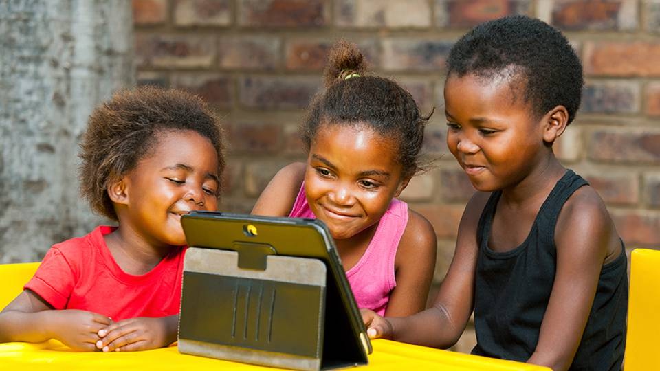 Young Kids brighten their faces after seeing a tablet from Anovatex Software Solutions